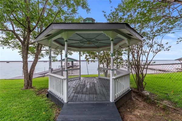 a view of a backyard with table and chairs under an umbrella