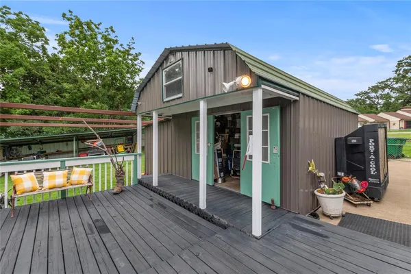 a view of a house with wooden deck