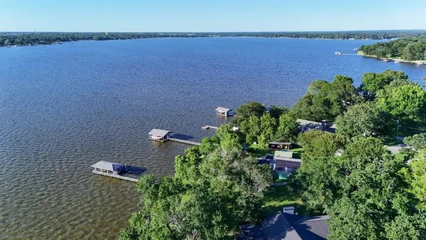 an aerial view of residential house with outdoor space and a lake view