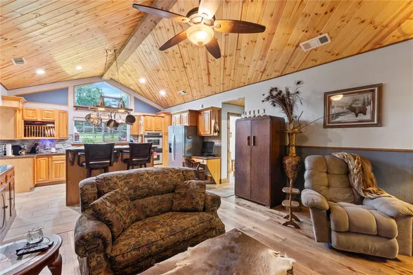 a living room with furniture and kitchen view