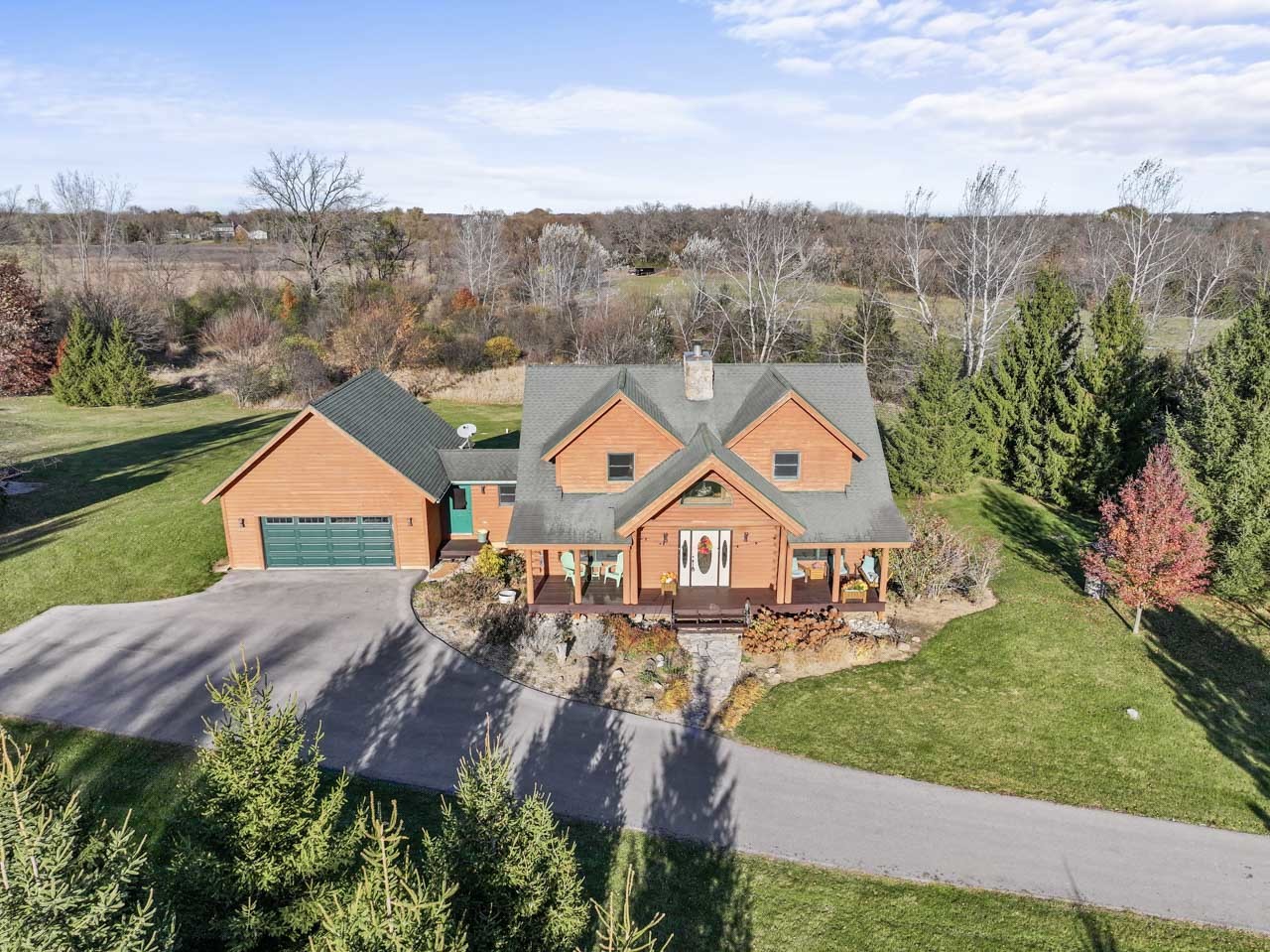 an aerial view of a house with a garden and trees