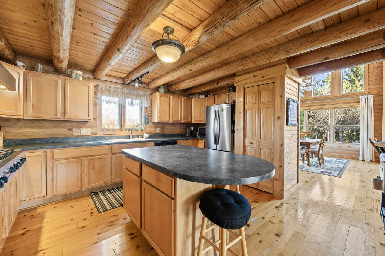 18508 128th Street Bristol, WI 53104 - Photo 18 of 48 a kitchen with stainless steel appliances granite countertop a stove a sink dishwasher and cabinets with wooden floor