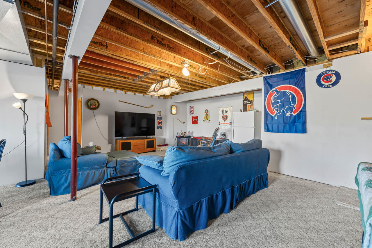 18508 128th Street Bristol, WI 53104 - Photo 31 of 48 a living room with furniture and a flat screen tv