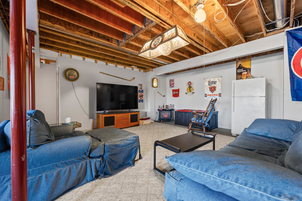 18508 128th Street Bristol, WI 53104 - Photo 32 of 48 a living room with furniture and a flat screen tv