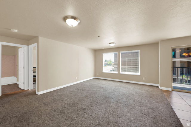 909 South Main Street, Unit G Layton, UT 84041 - Photo 7 of 25 Spacious room with plush gray carpeting, neutral-toned walls, and recessed lighting