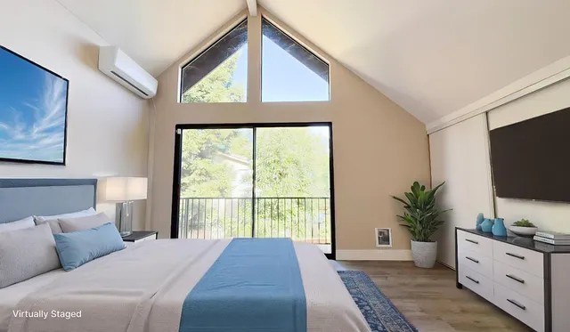 a bedroom with a large bed and a flat screen tv