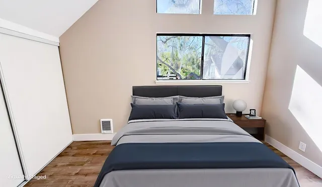 a bed sitting in a bedroom next to a window