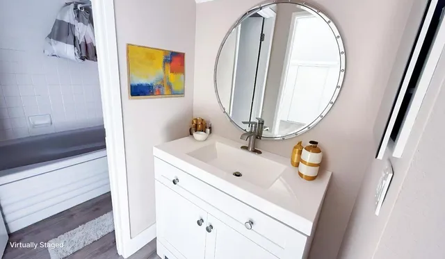 a bathroom with a sink a vanity and a mirror