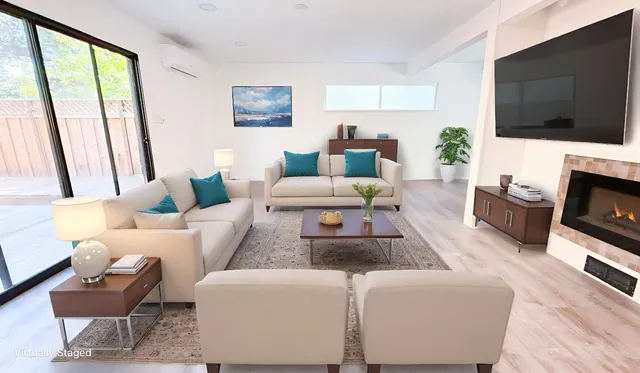 a living room with furniture a flat screen tv and a large window