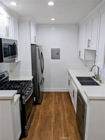 a kitchen with a stove a refrigerator and a sink