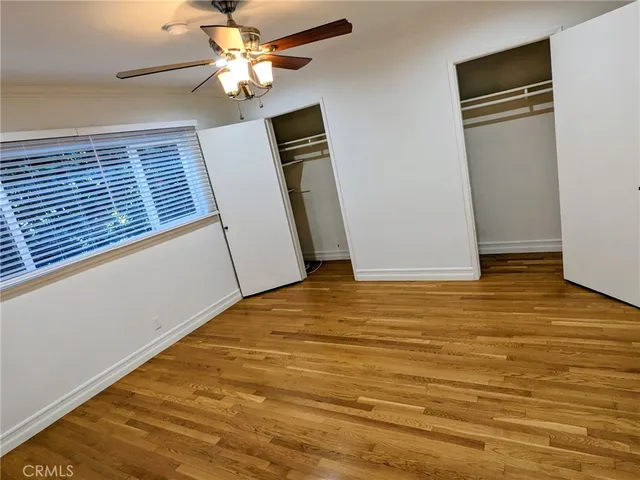 a view of a room with window and ceiling fan