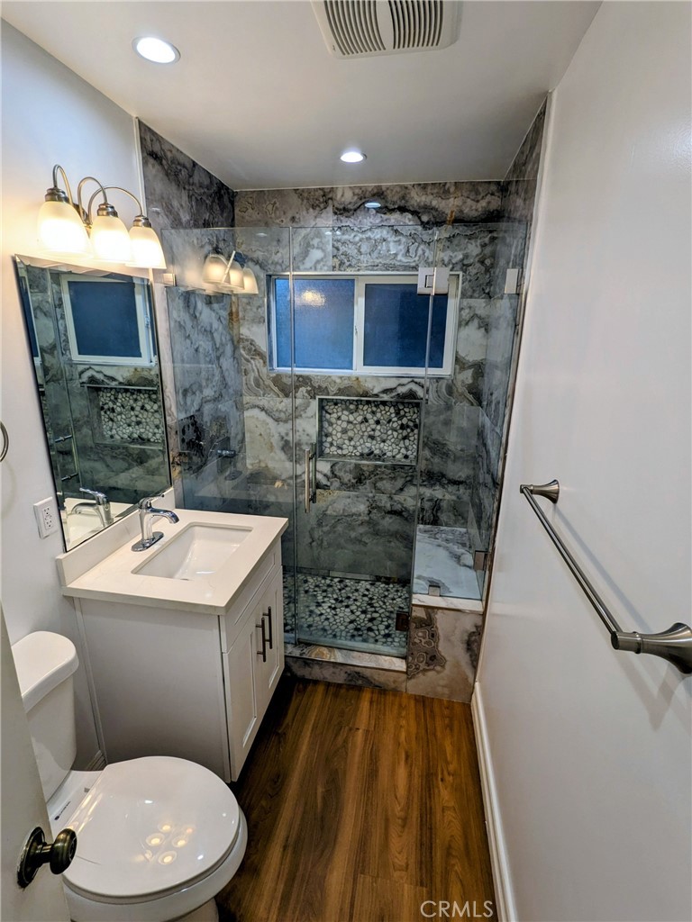 1019 6th Street, Unit 2 Santa Monica, CA 90403 - Photo 10 of 15 a bathroom with a sink a toilet and shower