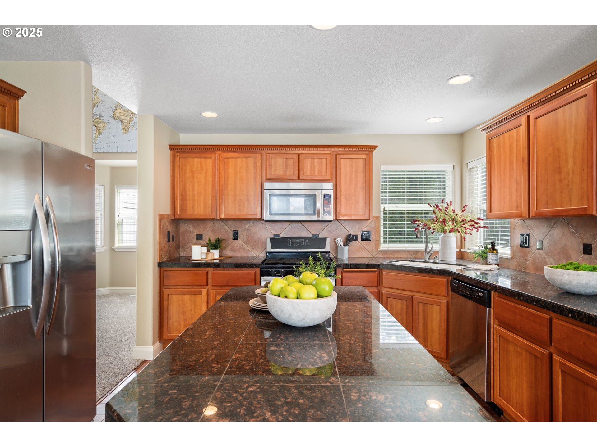 2597 North Lambert Street Cornelius, OR 97113 - Photo 15 of 48 a kitchen with stainless steel appliances granite countertop a sink a stove and a refrigerator