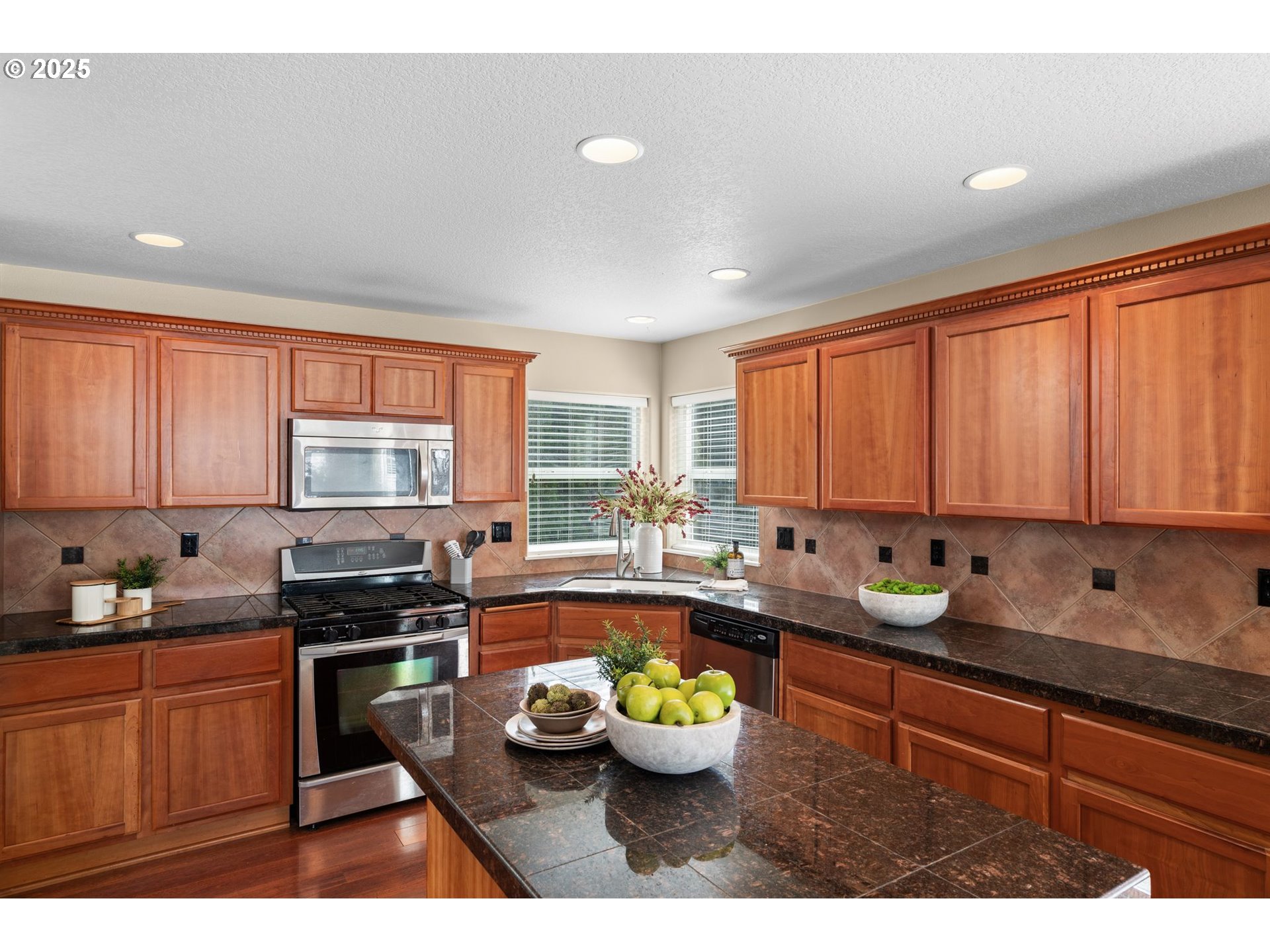 2597 North Lambert Street Cornelius, OR 97113 - Photo 16 of 48 a kitchen with kitchen island granite countertop a sink cabinets and window