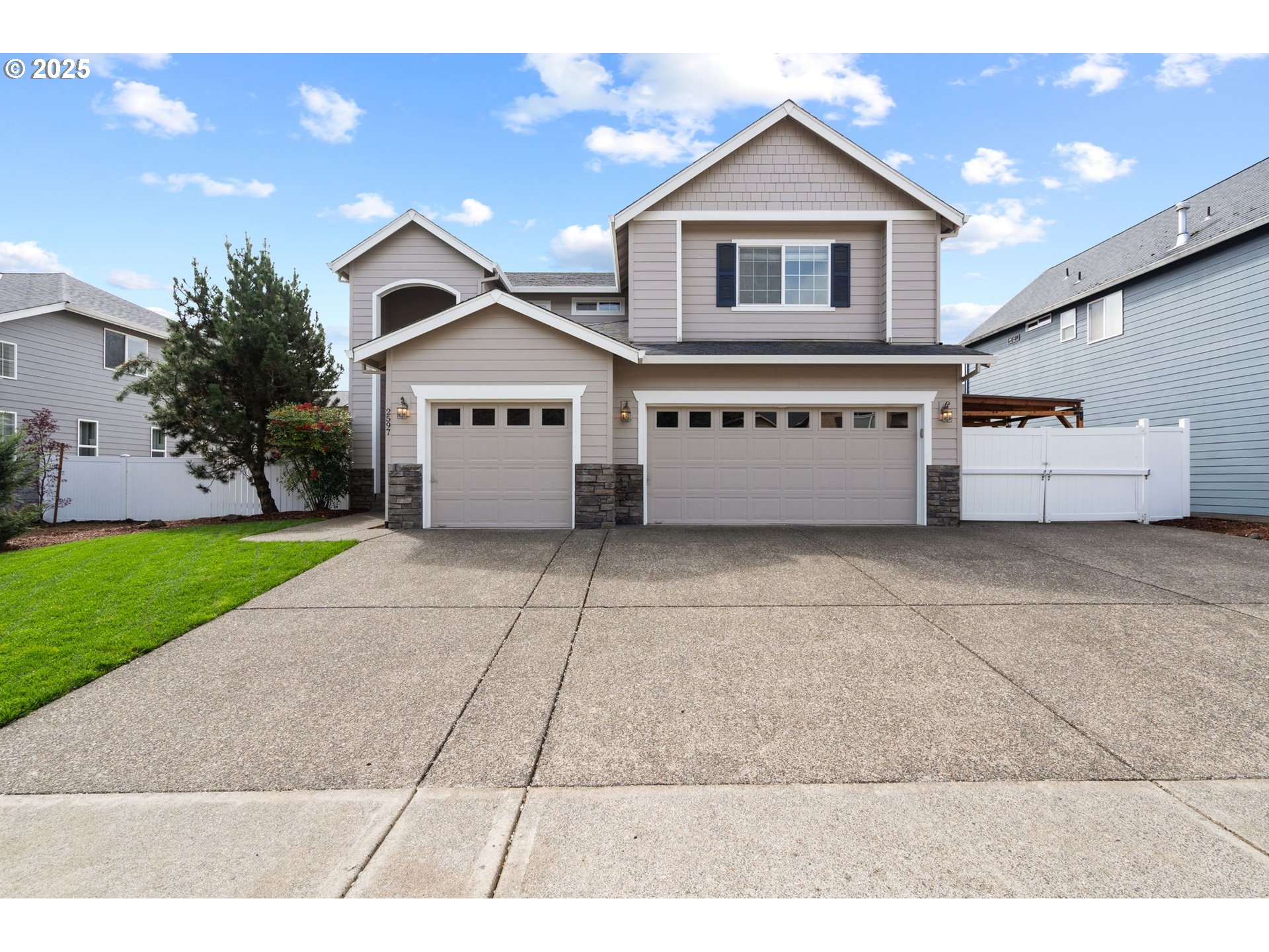 2597 North Lambert Street Cornelius, OR 97113 - Photo 3 of 48 a front view of a house with a yard and garage