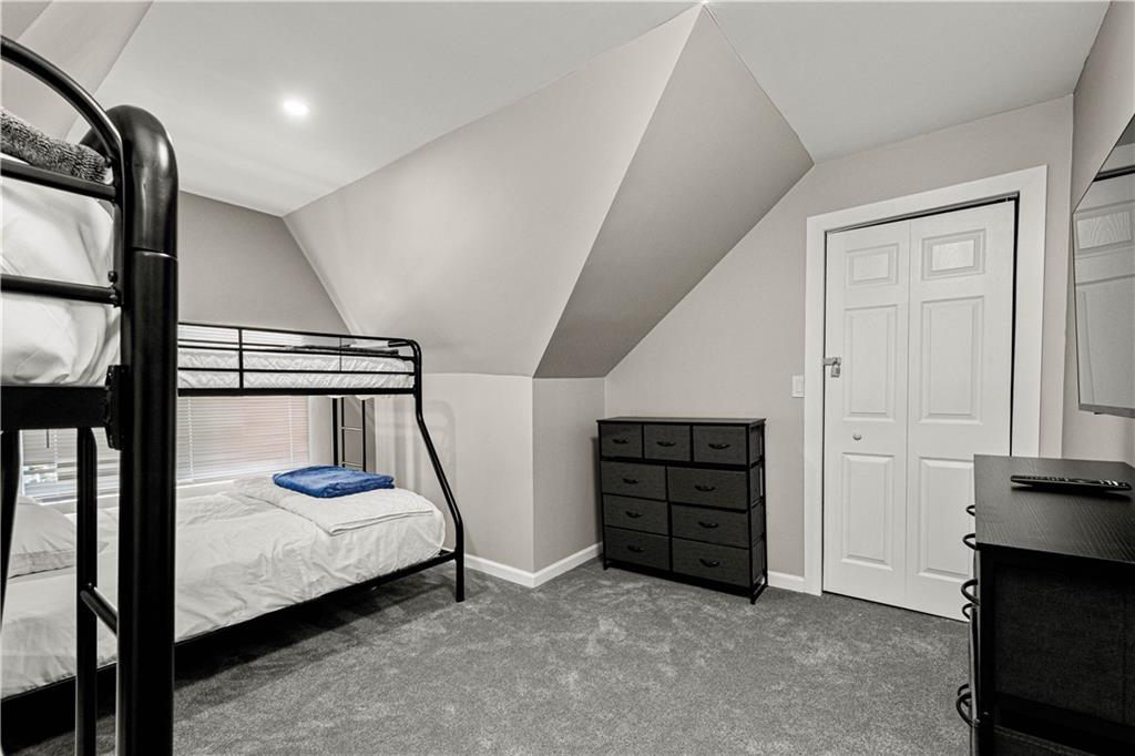 214 North Aiken Avenue Pittsburgh, PA 15206 - Photo 24 of 37 Third-floor bedroom with electric fireplace and wall-mounted TV