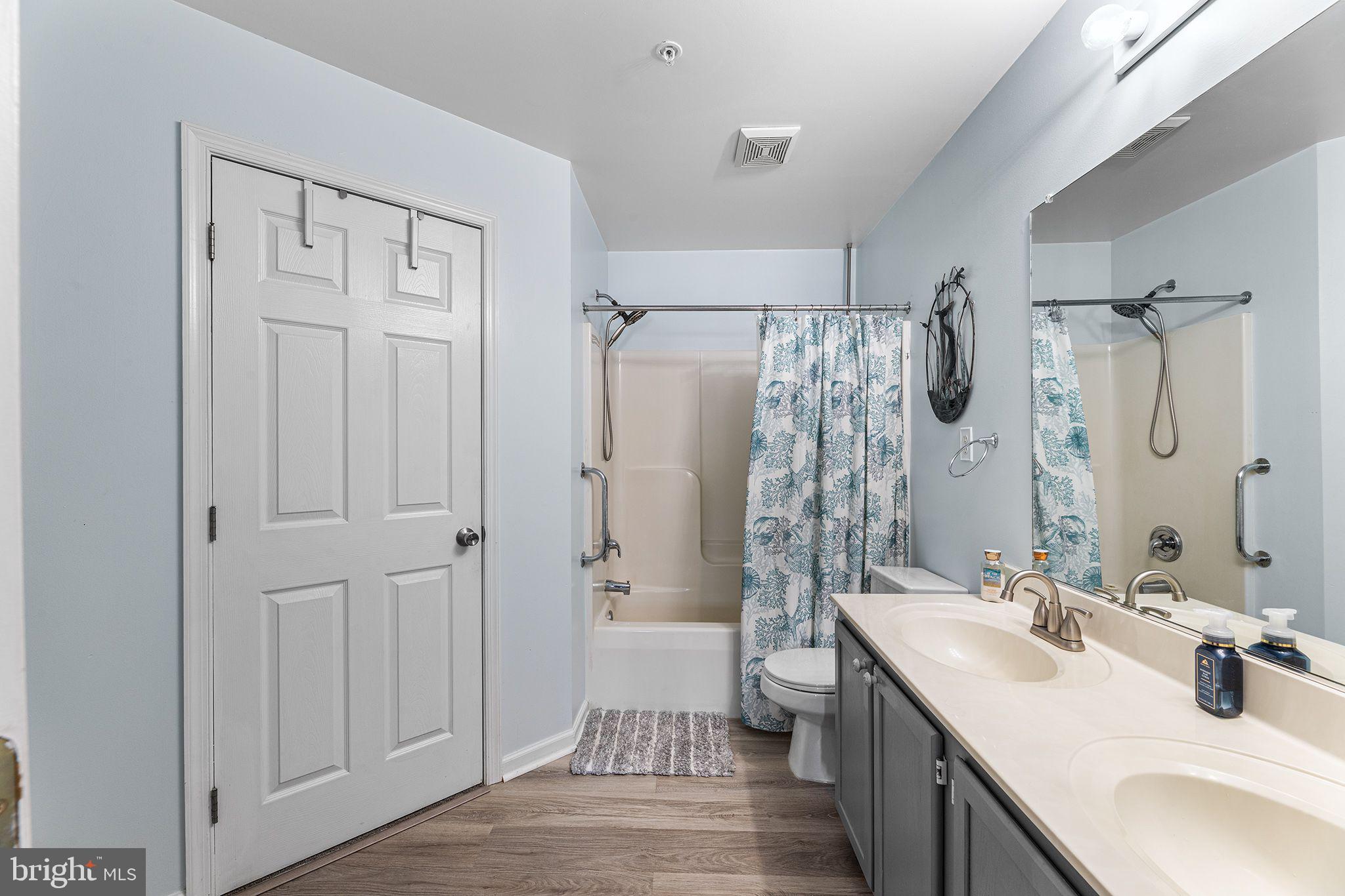 11431 Manklin Creek Road, Unit 5 Berlin, MD 21811 - Photo 18 of 38 a bathroom with a double vanity sink mirror double and shower