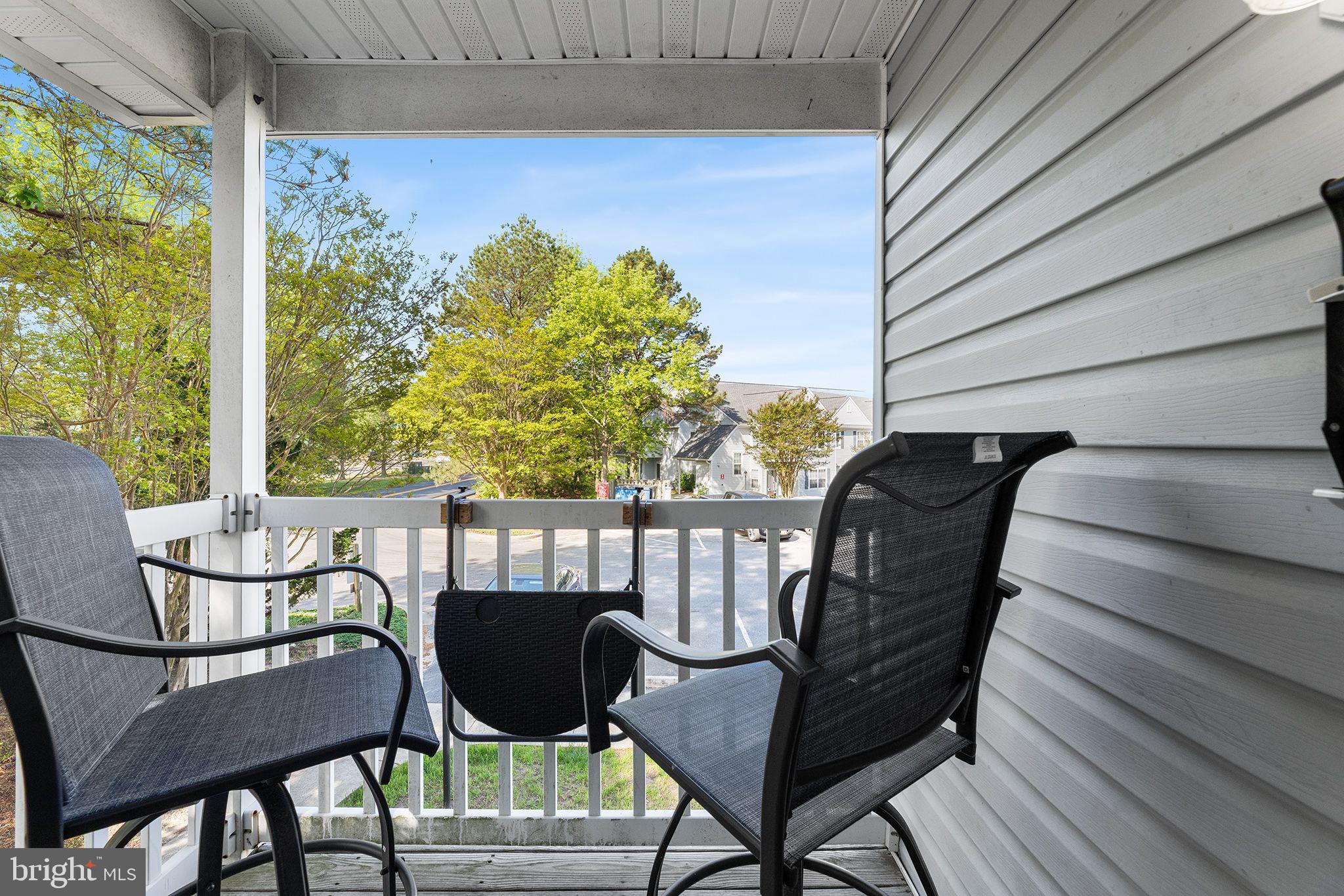 11431 Manklin Creek Road, Unit 5 Berlin, MD 21811 - Photo 21 of 38 a view of a chairs and table in patio