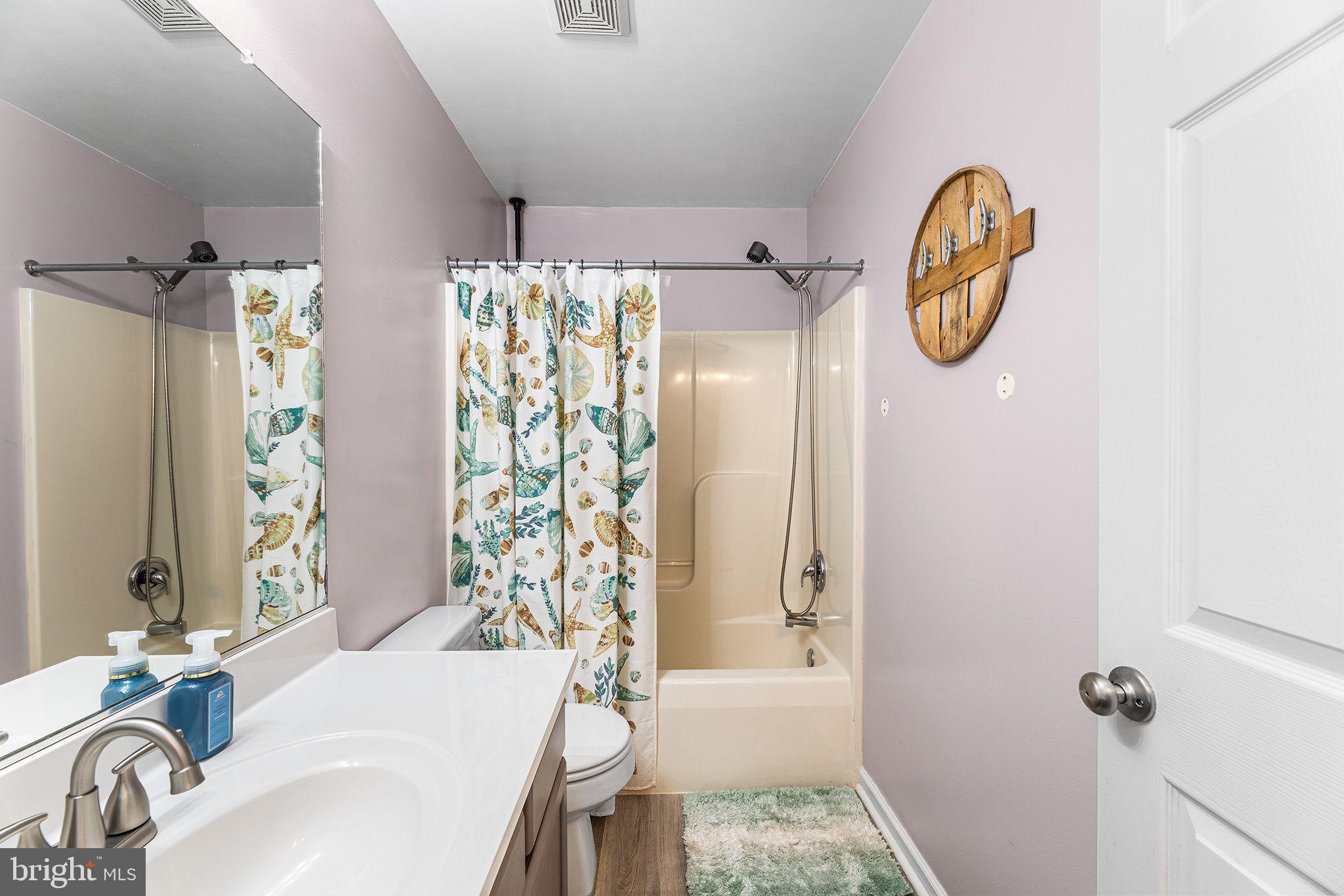 11431 Manklin Creek Road, Unit 5 Berlin, MD 21811 - Photo 23 of 38 a bathroom with a sink toilet and shower