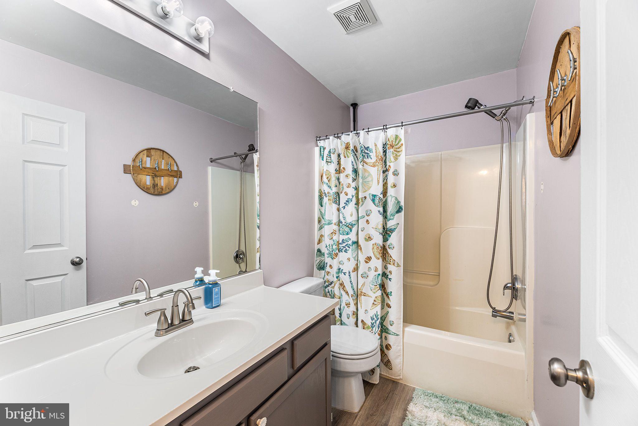 11431 Manklin Creek Road, Unit 5 Berlin, MD 21811 - Photo 24 of 38 a bathroom with a sink toilet and shower