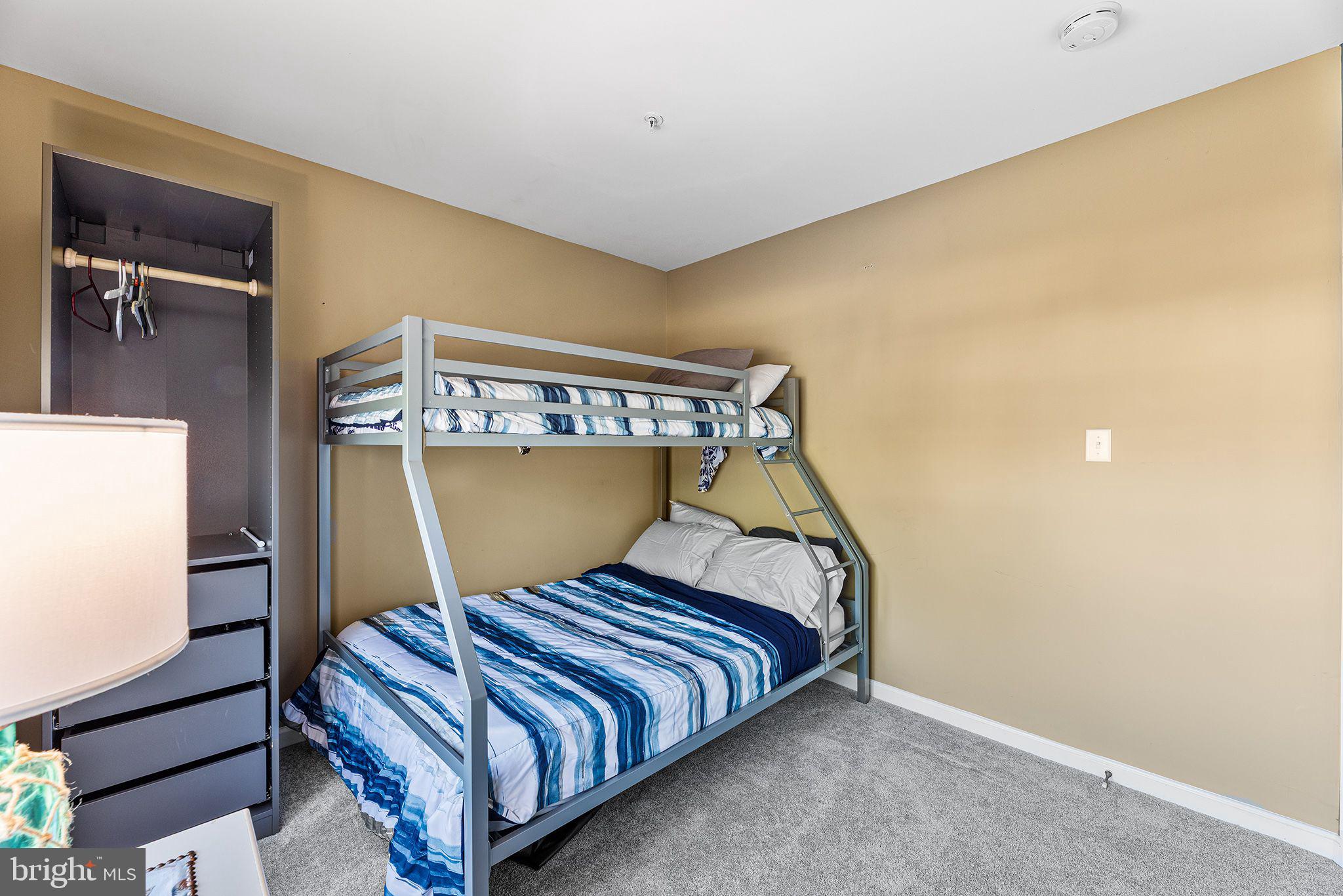 11431 Manklin Creek Road, Unit 5 Berlin, MD 21811 - Photo 29 of 38 a bed sitting in a bedroom next to a window