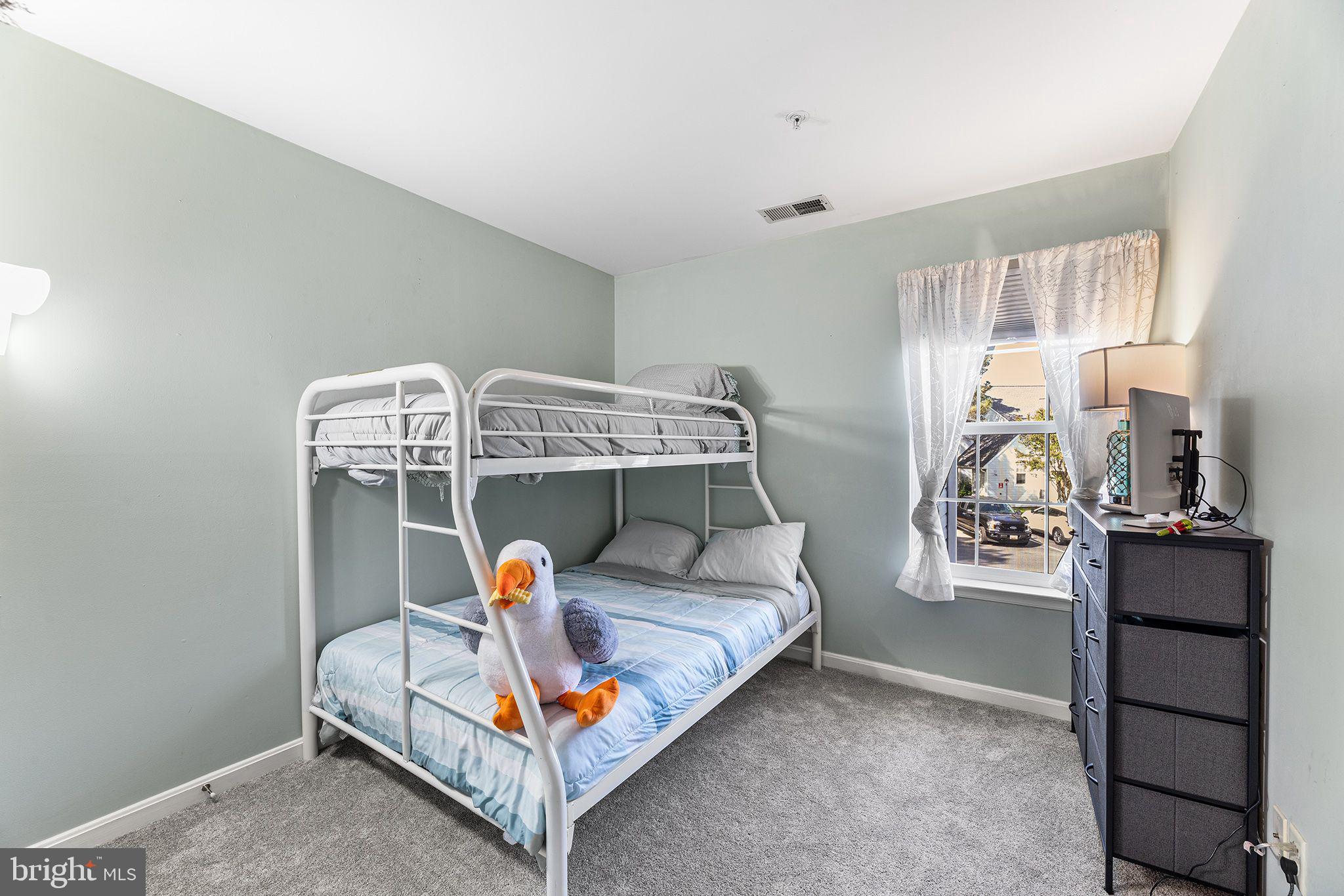 11431 Manklin Creek Road, Unit 5 Berlin, MD 21811 - Photo 30 of 38 a bedroom with furniture and window