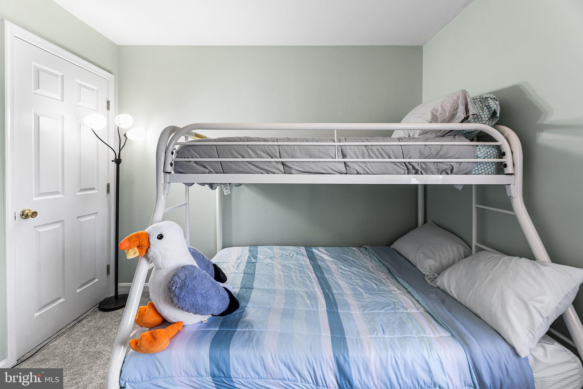 11431 Manklin Creek Road, Unit 5 Berlin, MD 21811 - Photo 31 of 38 a bedroom with a bed and wooden floor