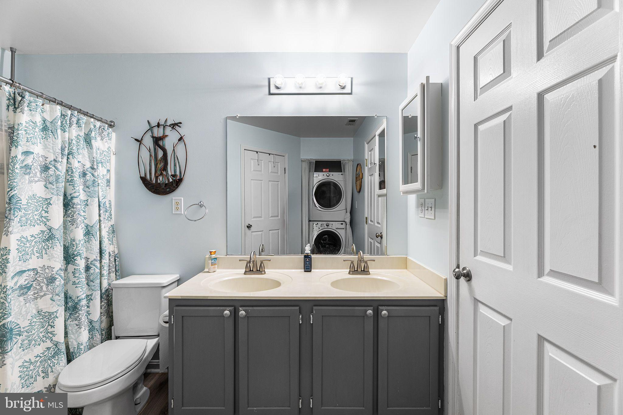 11431 Manklin Creek Road, Unit 5 Berlin, MD 21811 - Photo 33 of 38 a bathroom with a double vanity sink mirror and toilet