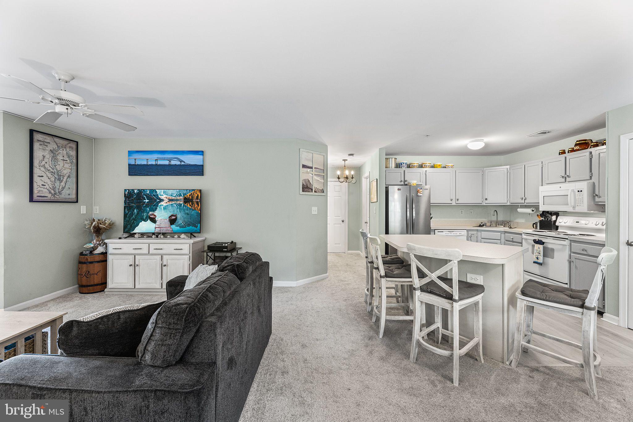 11431 Manklin Creek Road, Unit 5 Berlin, MD 21811 - Photo 5 of 38 a living room with furniture a dining table and chairs