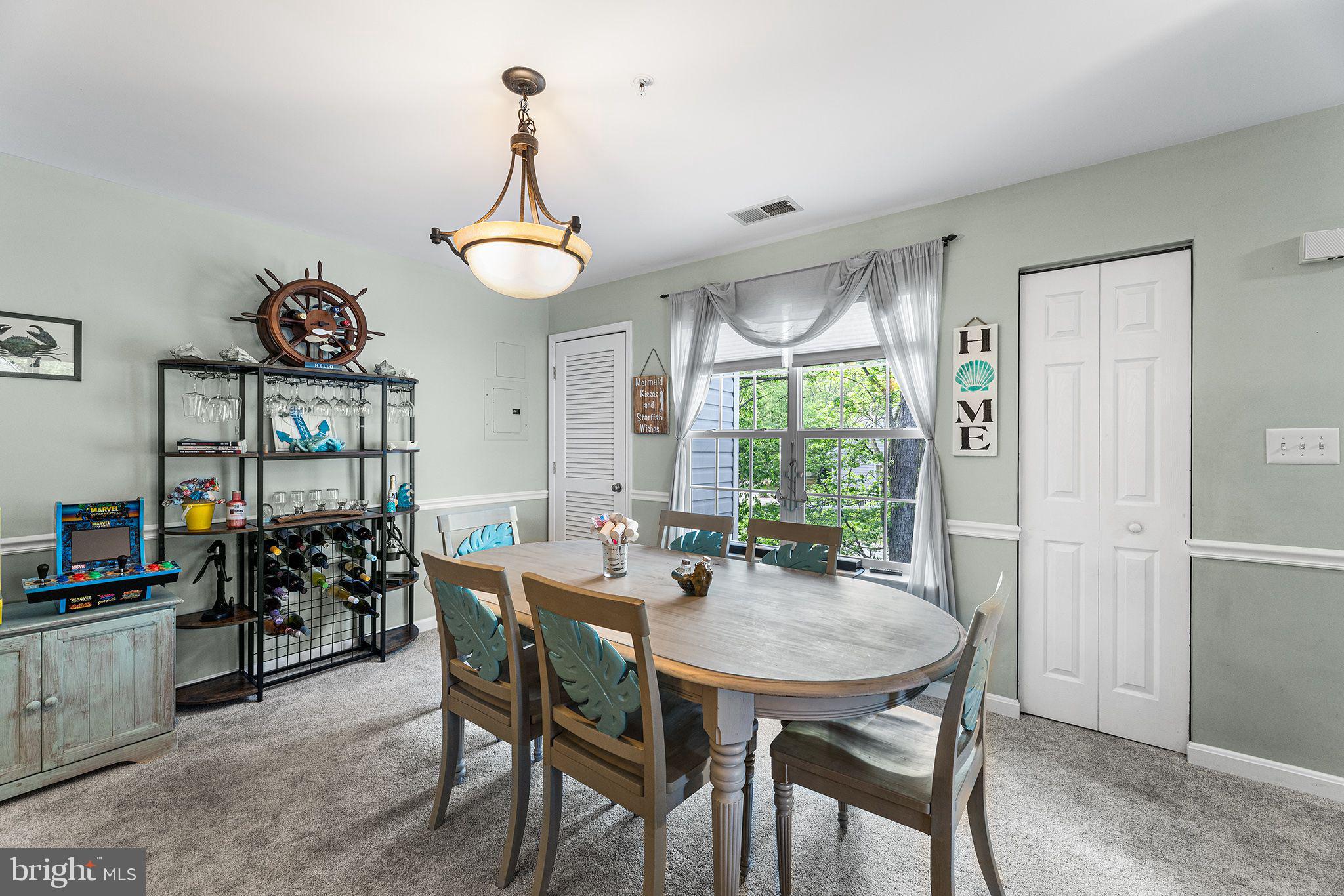 11431 Manklin Creek Road, Unit 5 Berlin, MD 21811 - Photo 8 of 38 a view of a dining room and livingroom with furniture wooden floor a chandelier