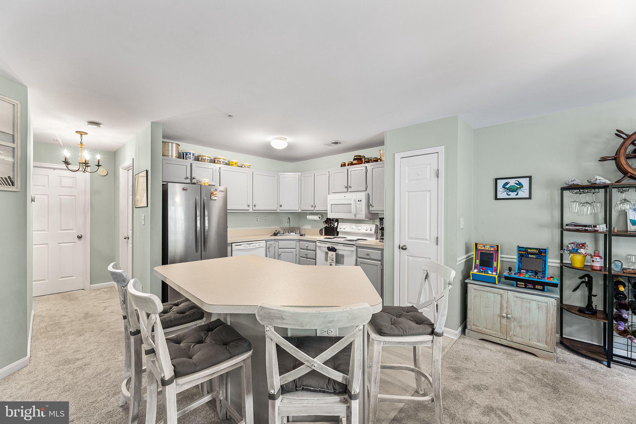 11431 Manklin Creek Road, Unit 5 Berlin, MD 21811 - Photo 9 of 38 a view of kitchen with refrigerator stove and workspace