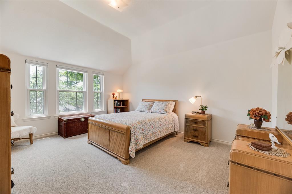 1406 West Peters Colony Road Carrollton, TX 75007 - Photo 14 of 29 a spacious bedroom with a bed and wooden floor