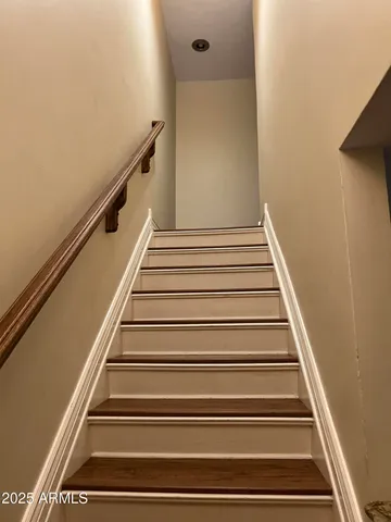 an empty room with wooden floor and a bathroom