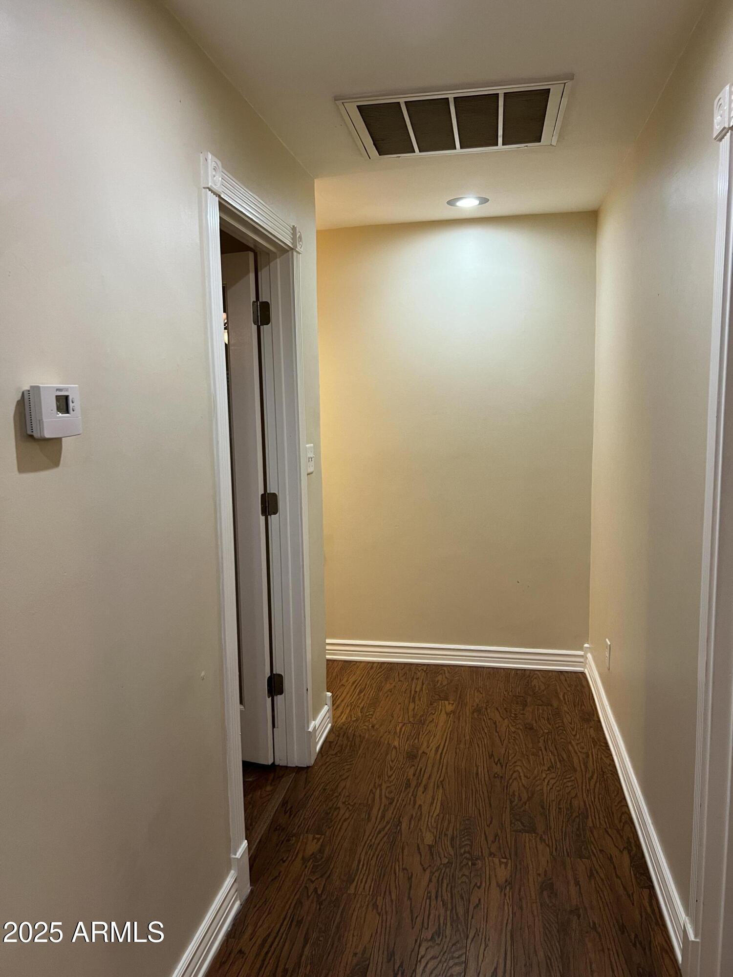 4573 South Mill Avenue Tempe, AZ 85282 - Photo 16 of 32 an empty room with wooden floor and a bathroom