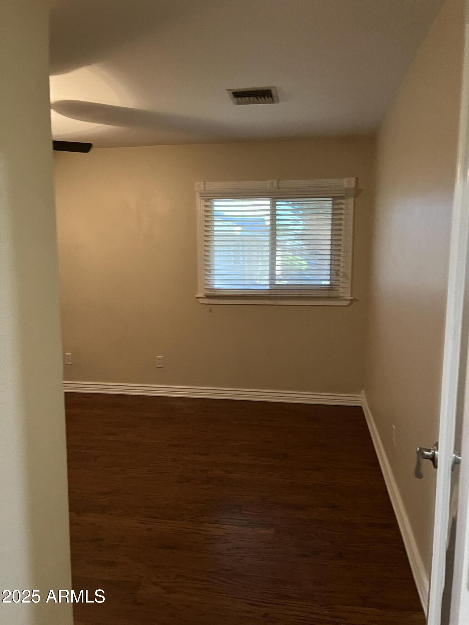 4573 South Mill Avenue Tempe, AZ 85282 - Photo 17 of 32 an empty room with wooden floor and windows