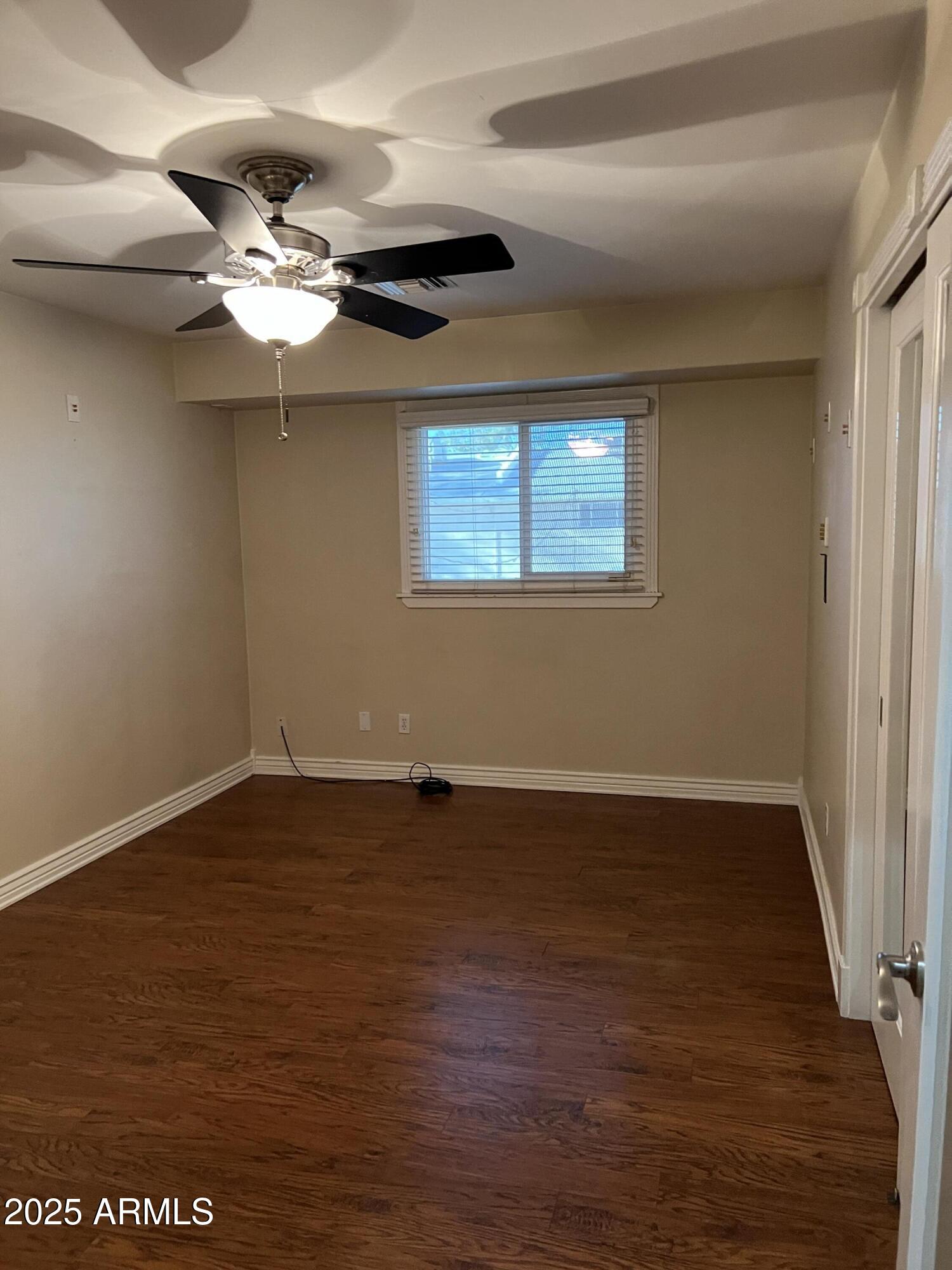 4573 South Mill Avenue Tempe, AZ 85282 - Photo 23 of 32 a view of an empty room with wooden floor and a window