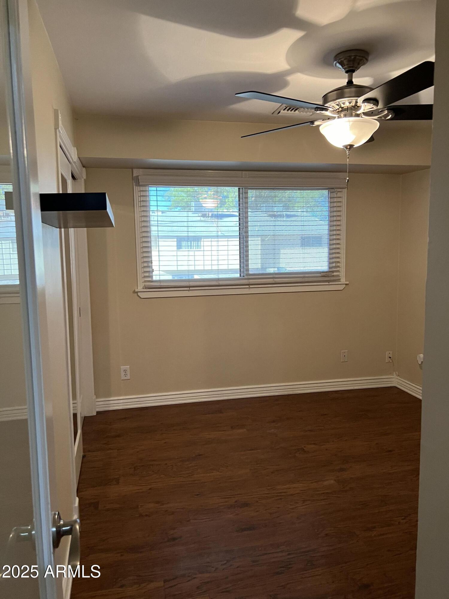 4573 South Mill Avenue Tempe, AZ 85282 - Photo 26 of 32 a view of an empty room with wooden floor and a window