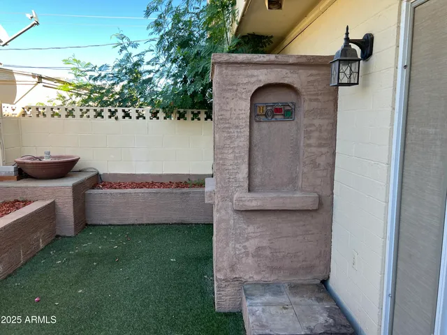 a backyard of a house with lots of trees and plants