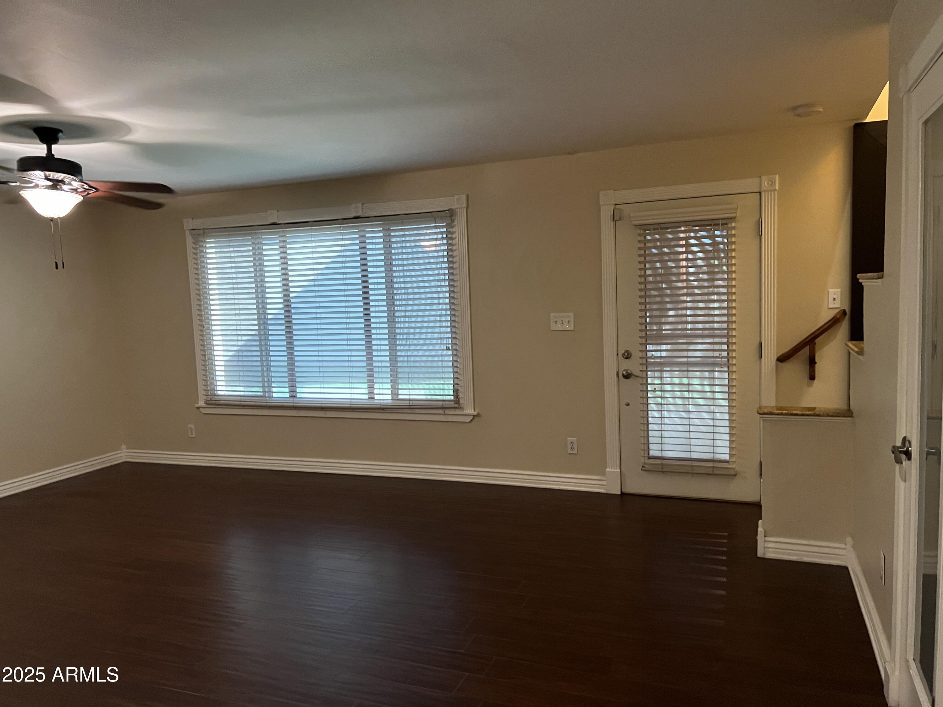 4573 South Mill Avenue Tempe, AZ 85282 - Photo 3 of 32 a view of an empty room with a window and wooden floor