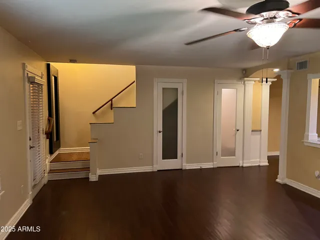 wooden floor in an empty room with a window
