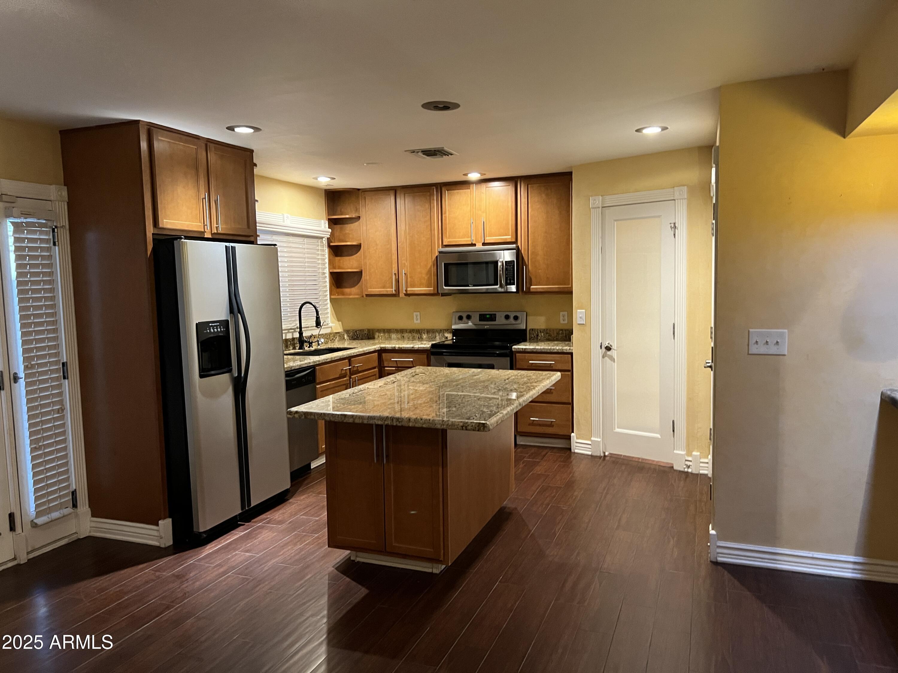 4573 South Mill Avenue Tempe, AZ 85282 - Photo 7 of 32 a kitchen with a refrigerator sink and cabinets