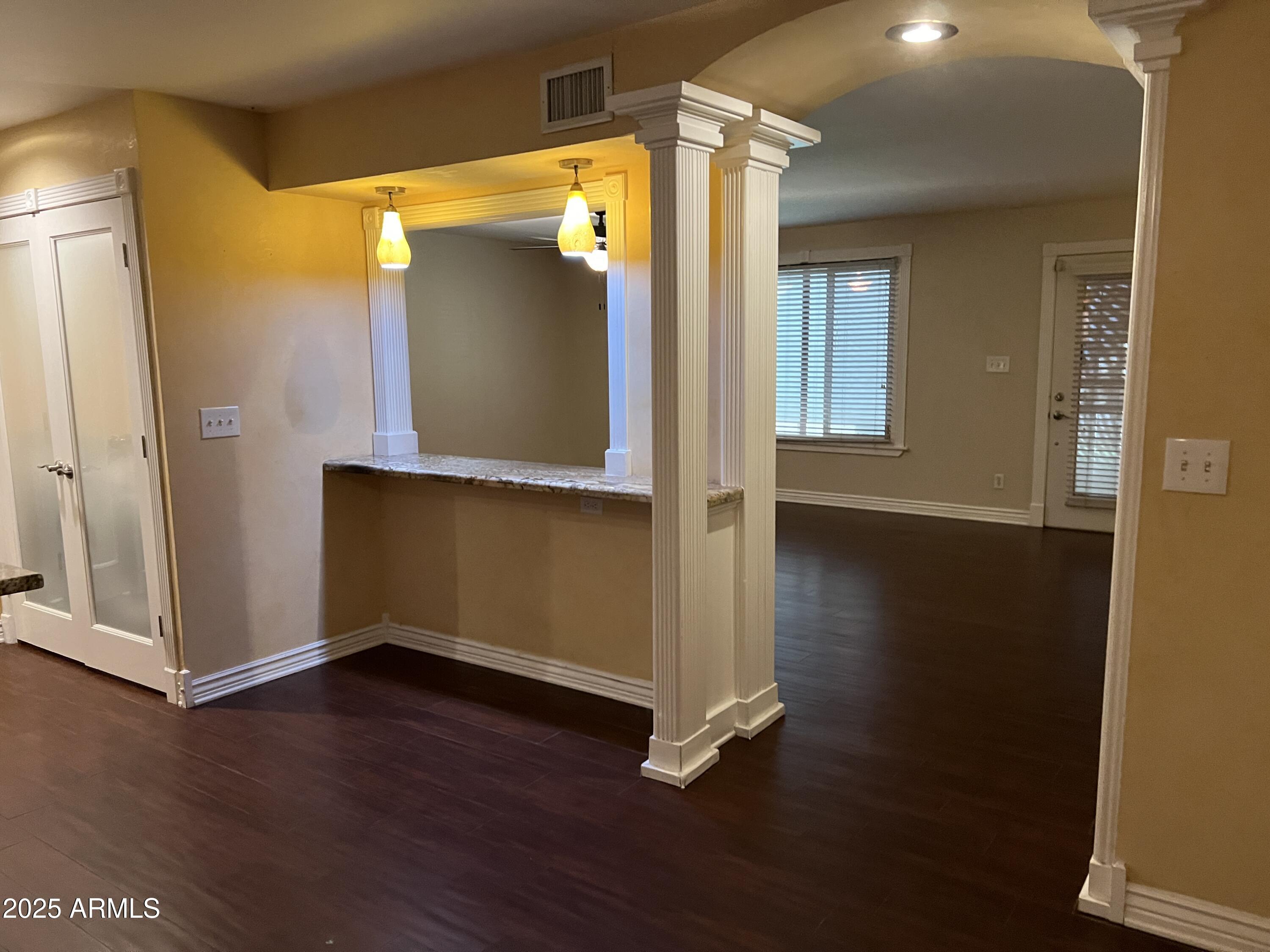4573 South Mill Avenue Tempe, AZ 85282 - Photo 10 of 32 an empty room with wooden floor and windows