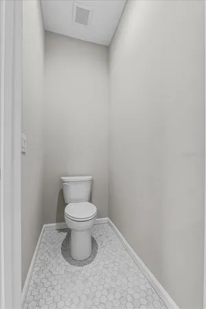 a white toilet sitting in a bathroom
