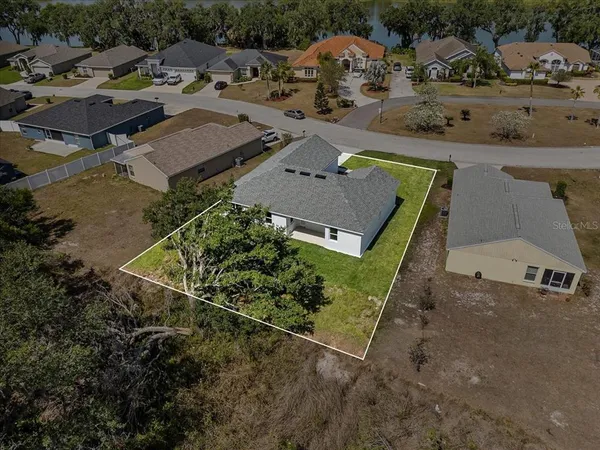 an aerial view of residential building with outdoor space and lake view