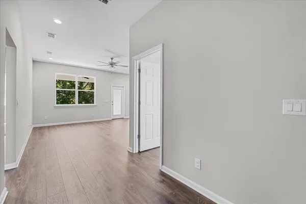 an empty room with windows and closet