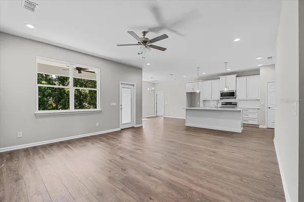 a view of kitchen with sink and wooden floor