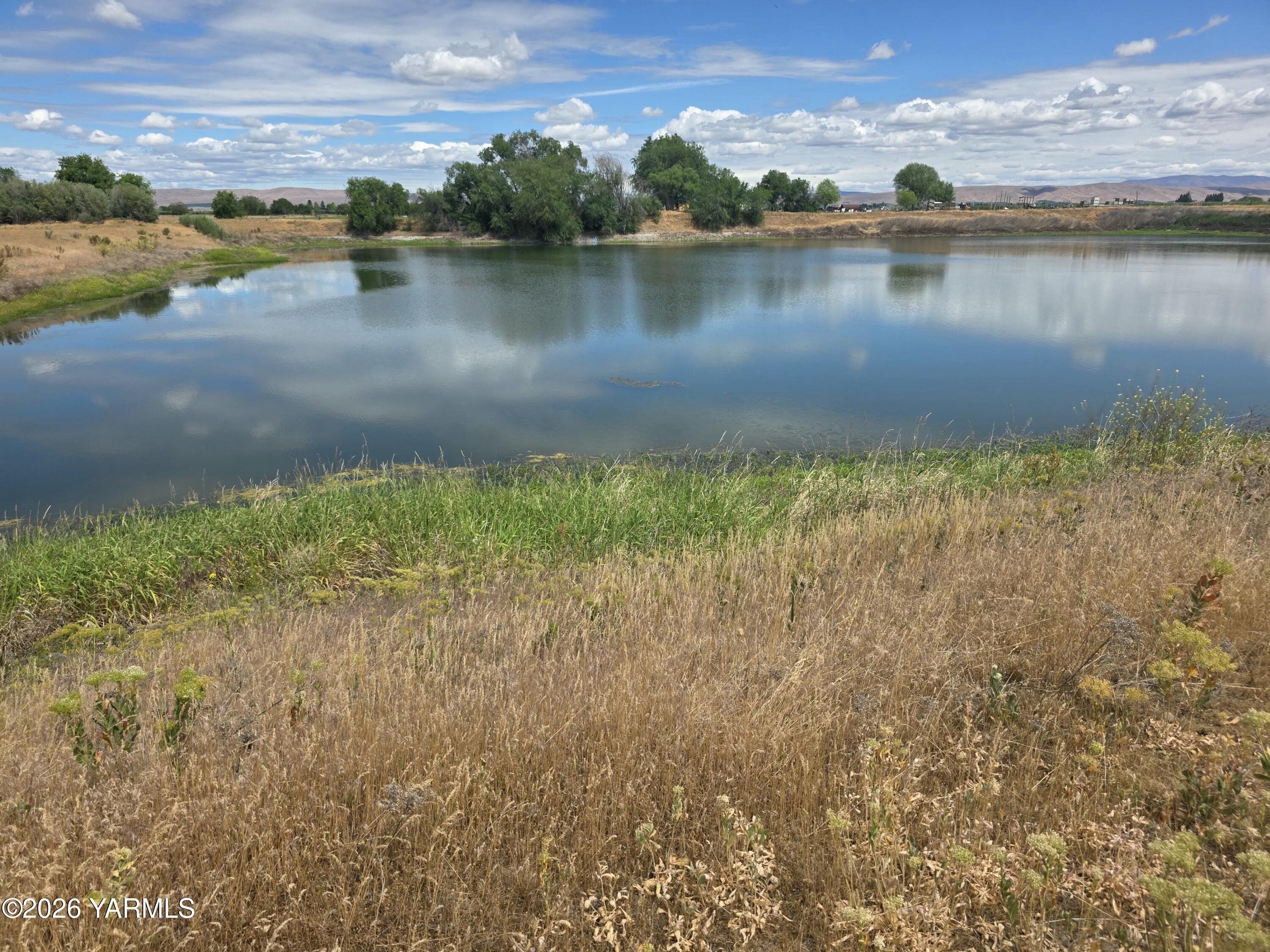 5451 Branch Road Wapato, WA 98951 - Photo 4 of 9 a view of a lake with houses in the background