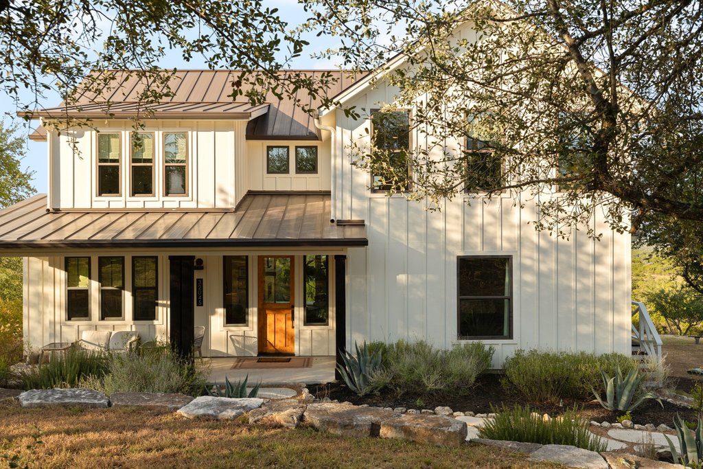 32045 Mirela Ann Road Dripping Springs, TX 78620 - Photo 32 of 36 Board and batten siding pairs beautifully with a metal roof on this modern farmhouse design.