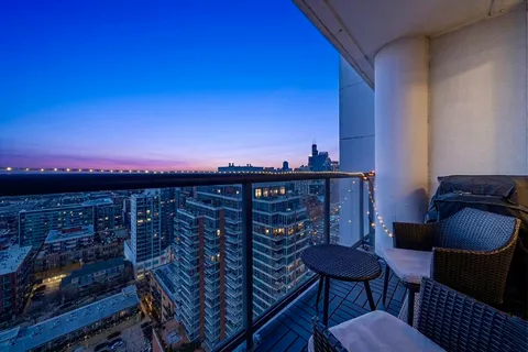 a kitchen with stainless steel appliances granite countertop a refrigerator a sink dishwasher and a stove with wooden floor