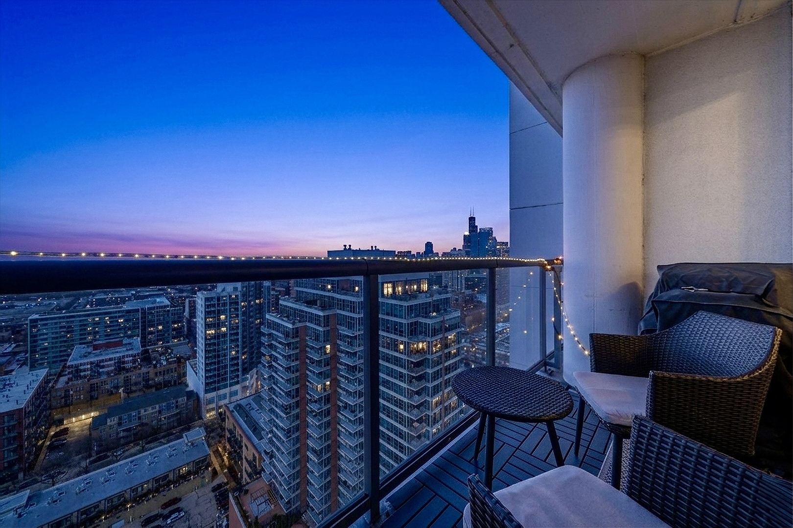 1629 South Prairie Avenue, Unit 2709 Chicago, IL 60616 - Photo 13 of 37 a view of a balcony with chairs and a potted plant